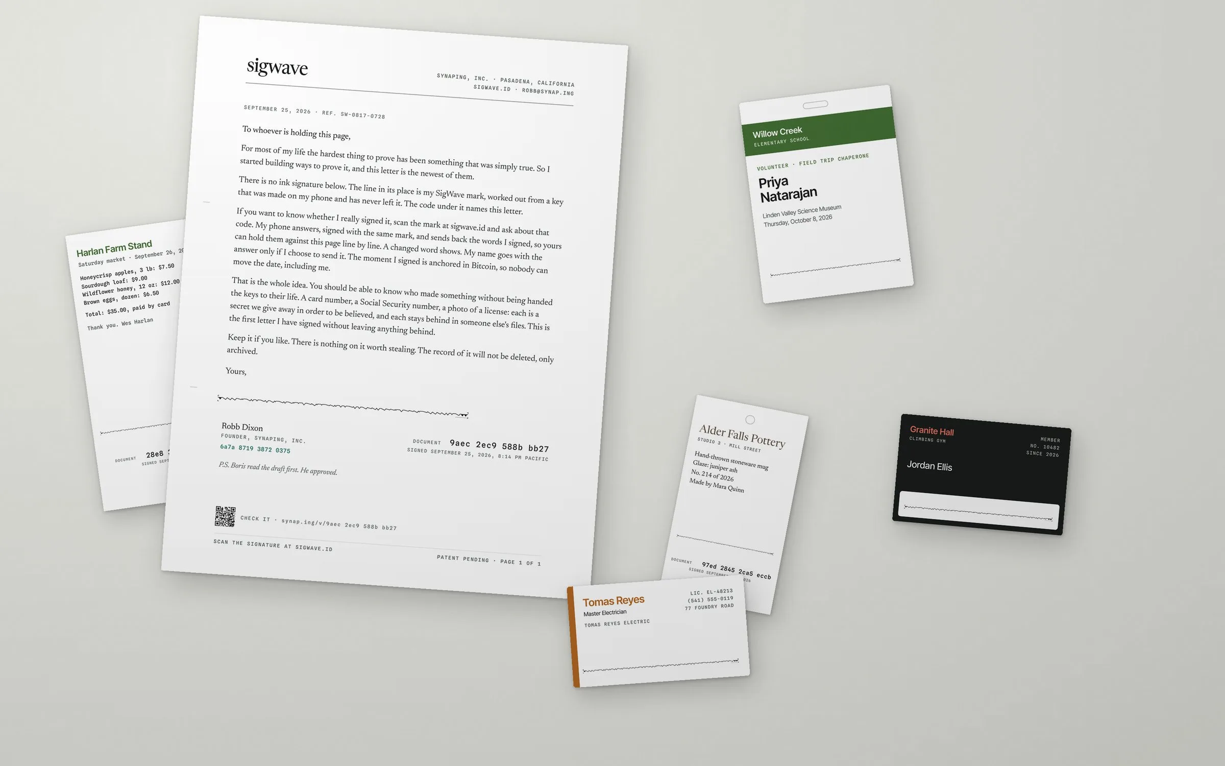 A signed letter, a school badge, a business card, a gym card, a maker's tag and a receipt on a desk